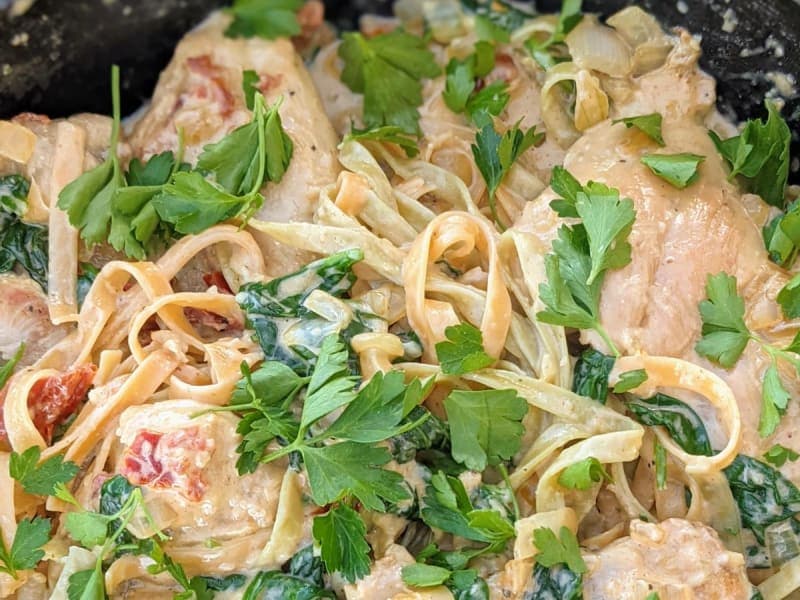 Creamy Chicken with sun-dried tomatoes over pasta