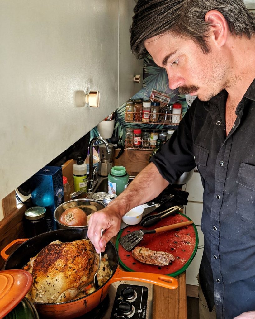 Andy is cooking a turkey in a pan on a hob